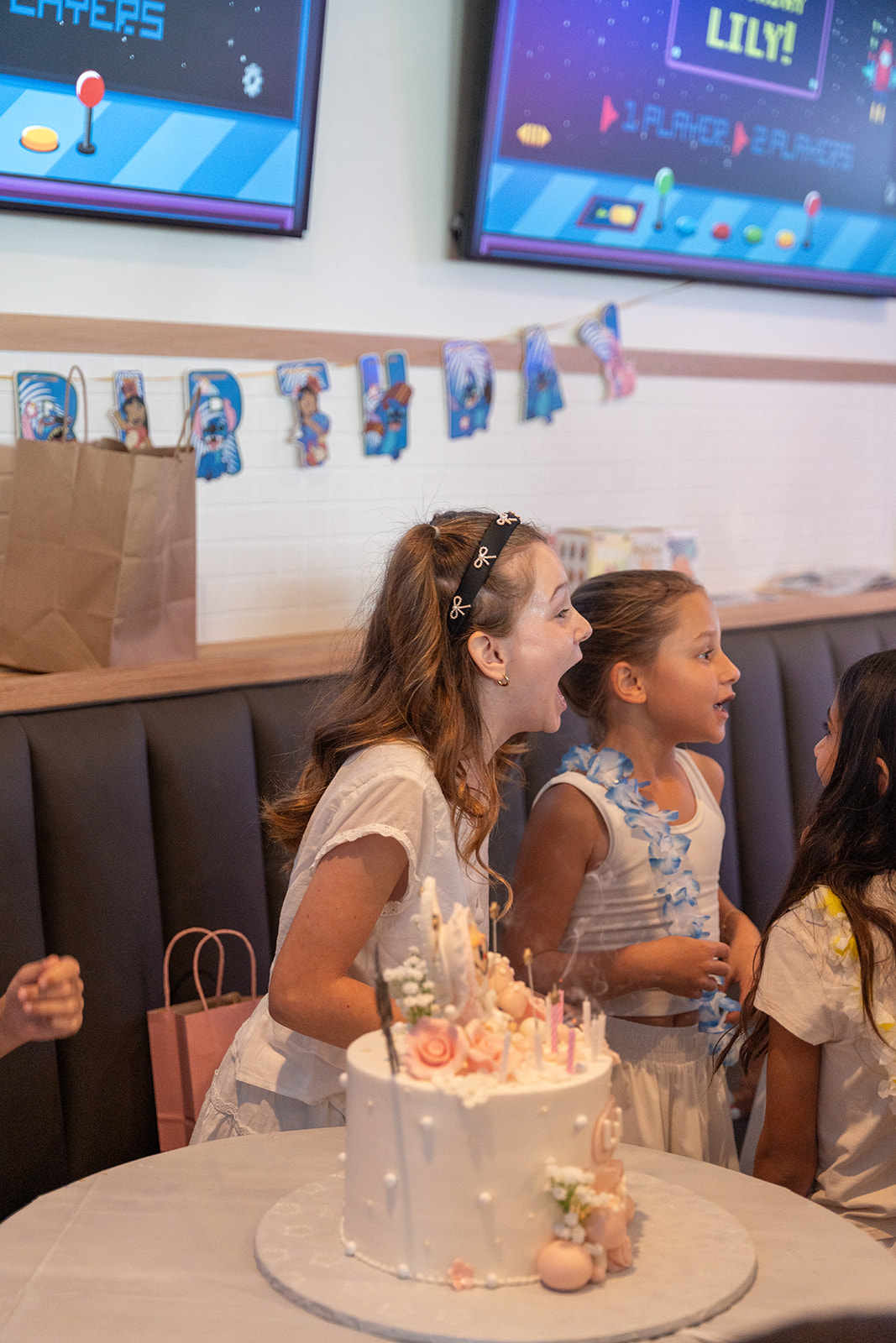 a woman sitting at a table in front of a cake
