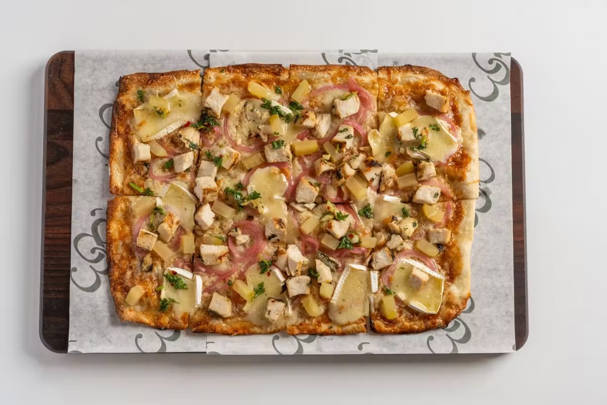 Brie and apple flatbread with roasted herb chicken and pickled red onions at 1983 in Tampa