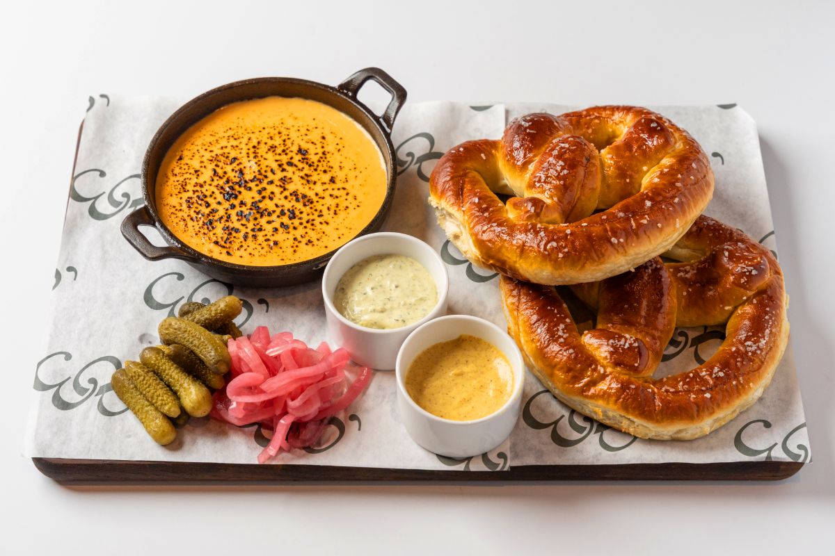 Soft pretzel board with cheese fondue and pickled vegetables during Social Hour at 1983 Tampa