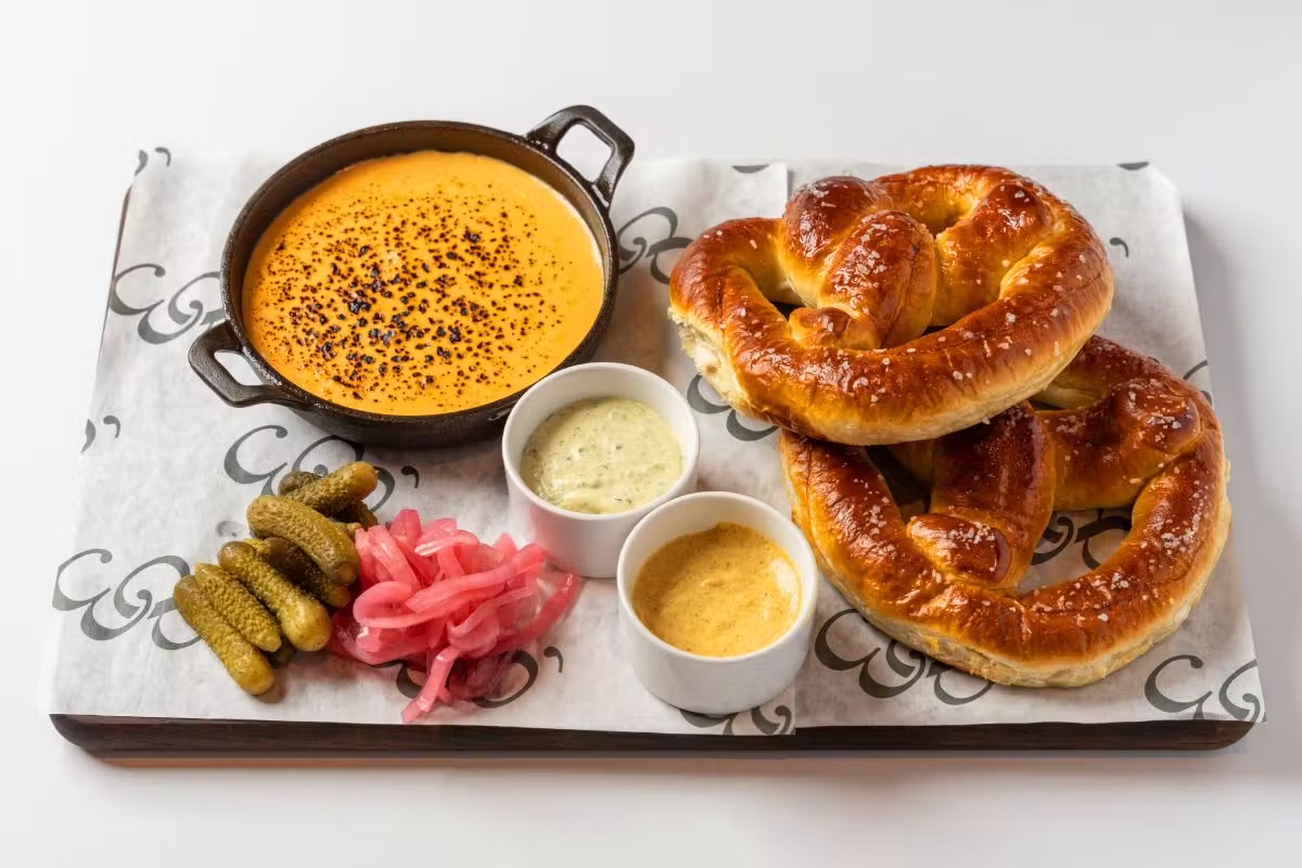 Soft pretzel board with cheese fondue and pickled vegetables served late night at 1983 Tampa