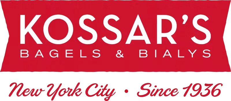 Red and black logo for Kossar's Bagels & Bialys. Bold white text on red reads "Kossar's"; below in smaller font, "Bagels & Bialys." "New York City • Since 1936" is in red cursive on black.