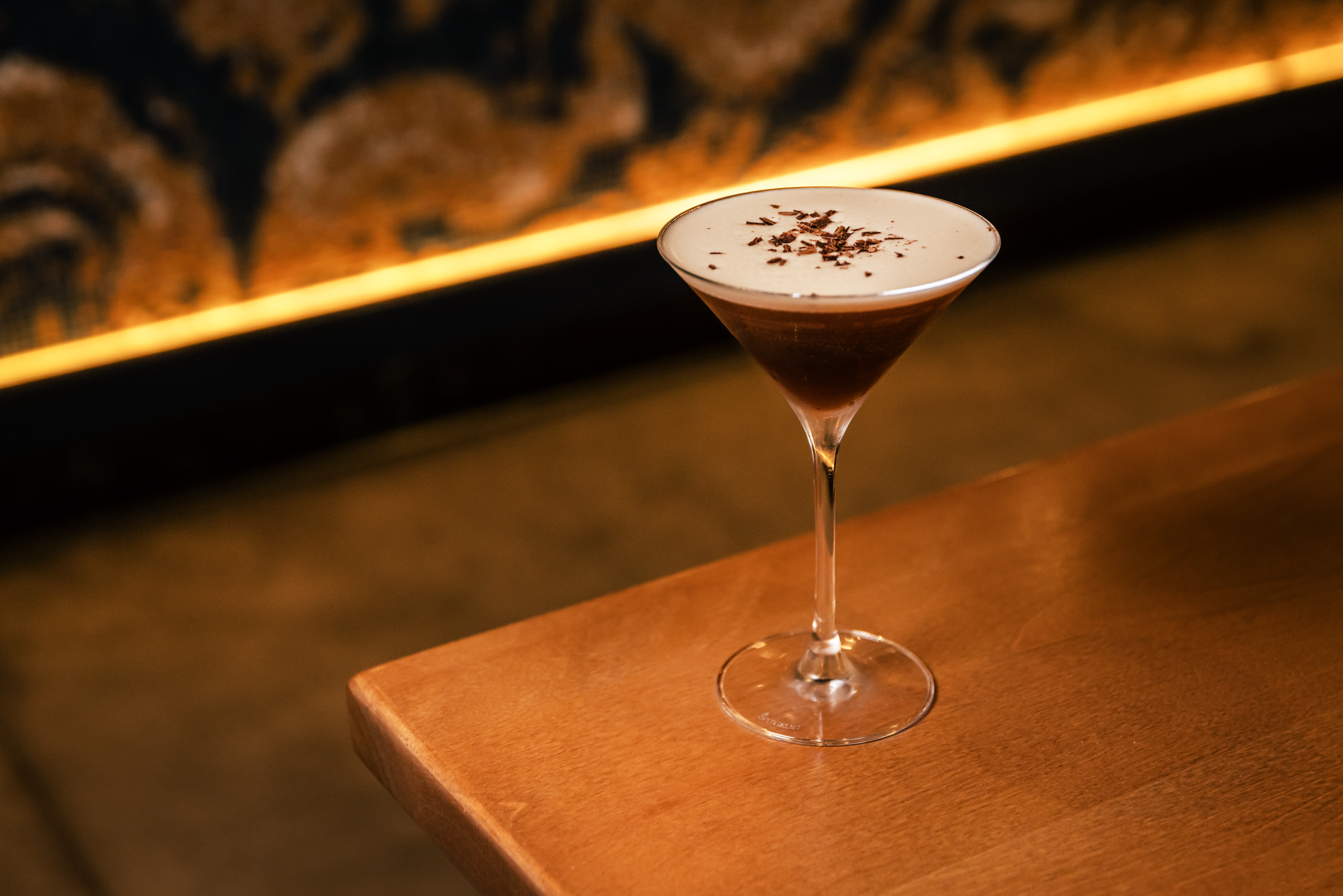 a martini glass with a brown liquid in it