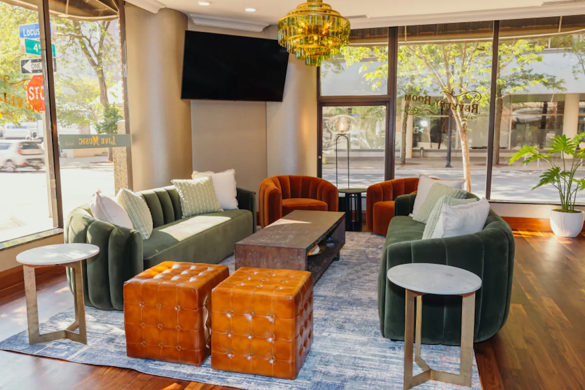 a living room filled with furniture and a large window