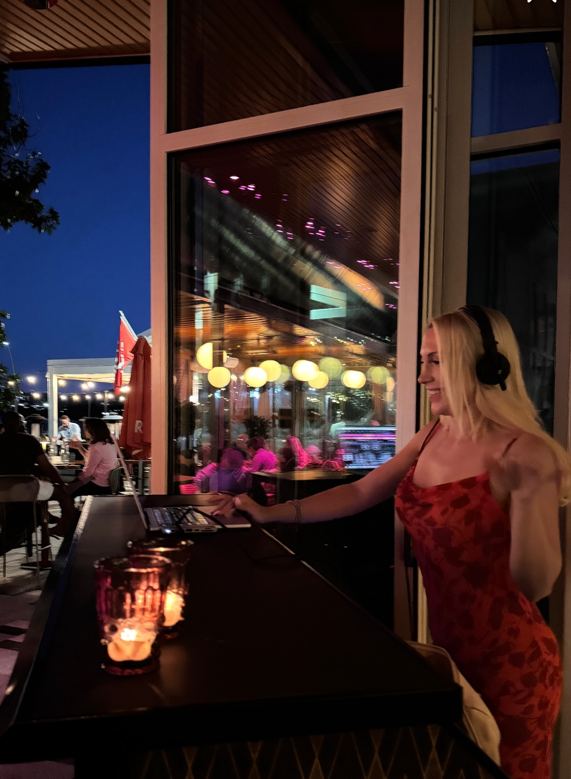 a person sitting at a table in front of a window