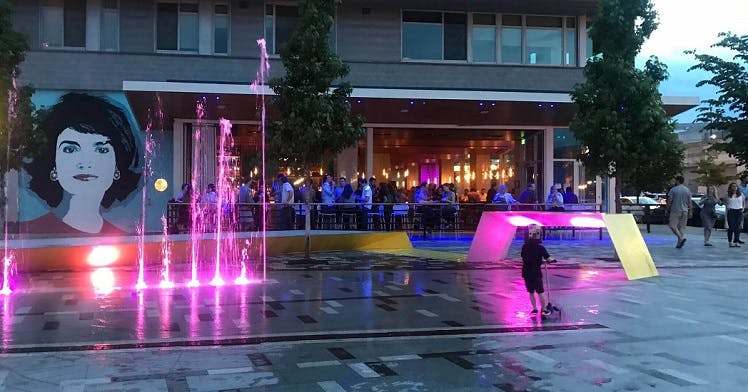 a group of people walking in front of a building