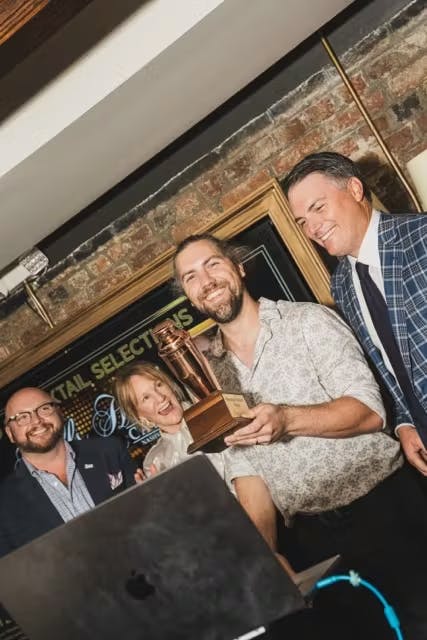 a group of people looking at a laptop