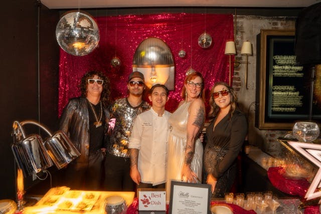 a couple of people that are standing in front of a cake