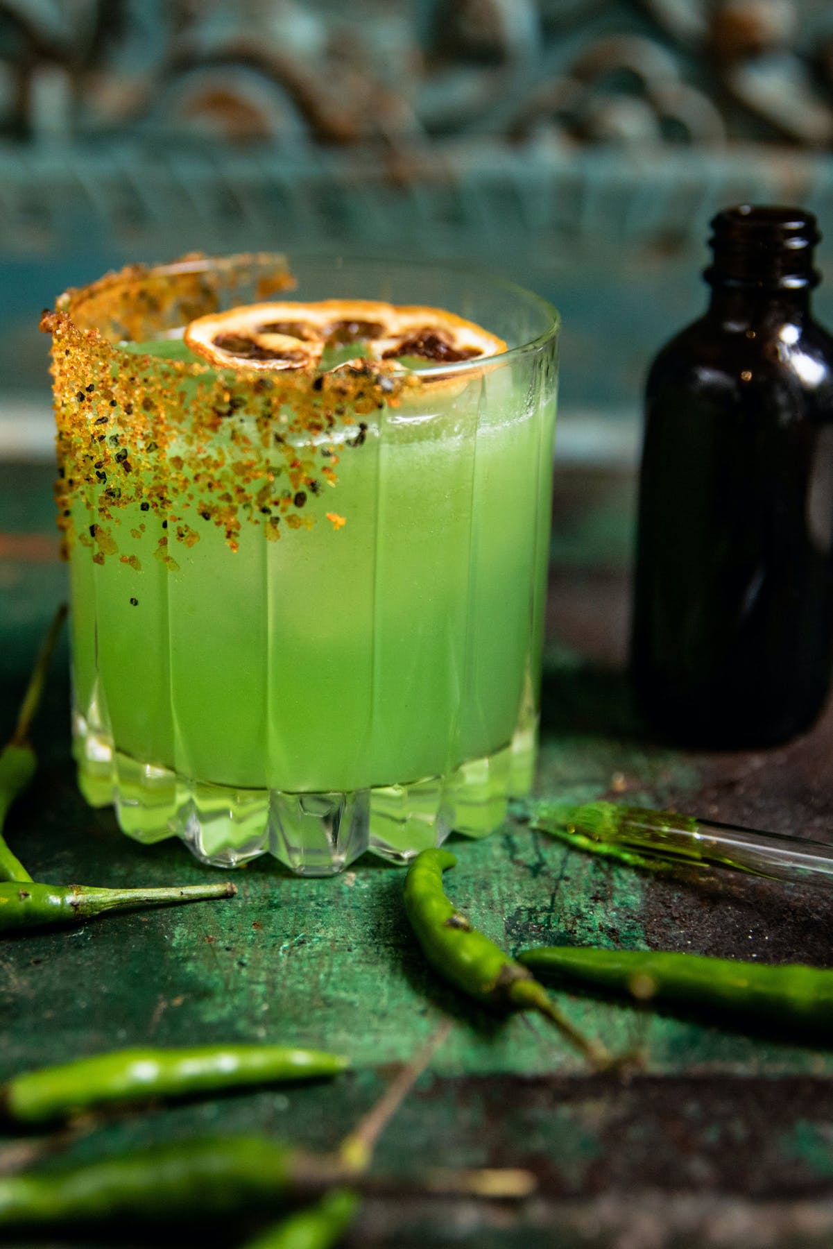 a close up of a glass cup on a green table