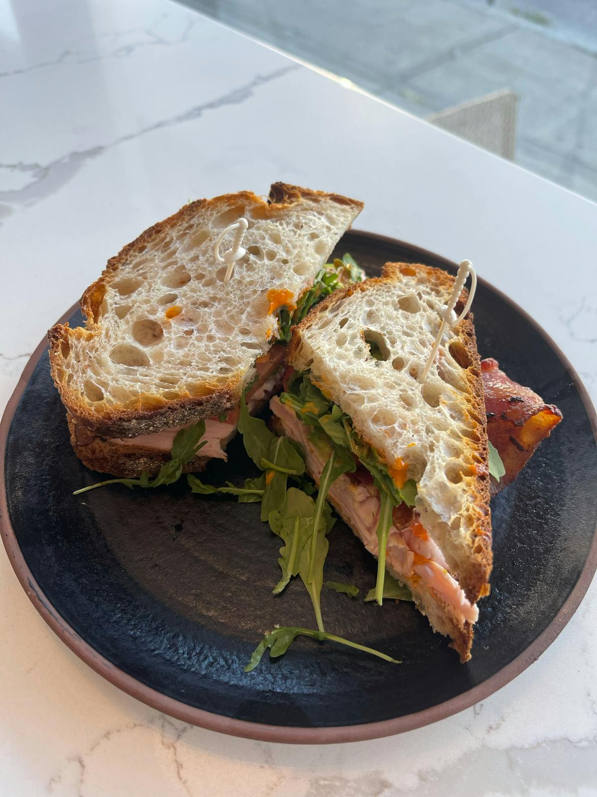 a half eaten sandwich on a plate