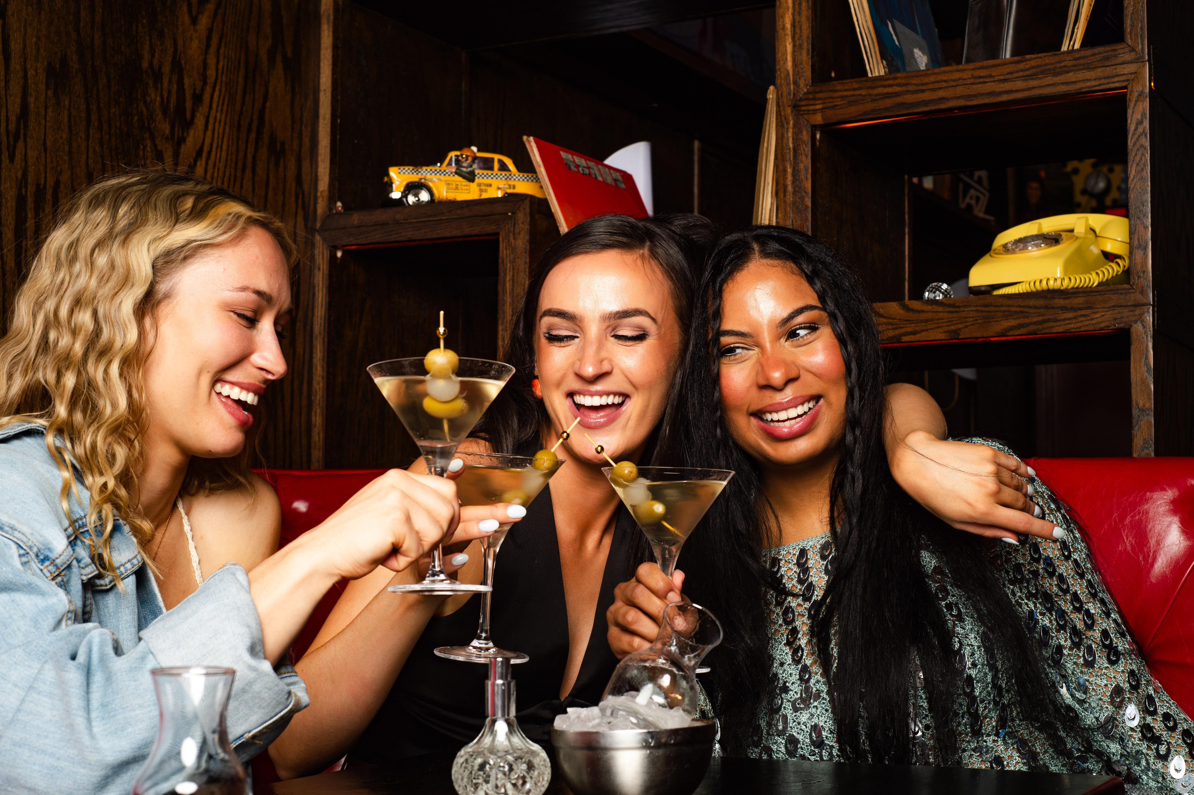 a woman sitting at a table with wine glasses