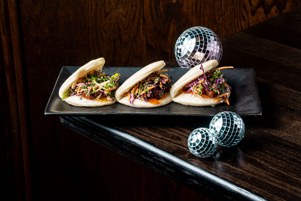a plate of food sitting on top of a wooden table