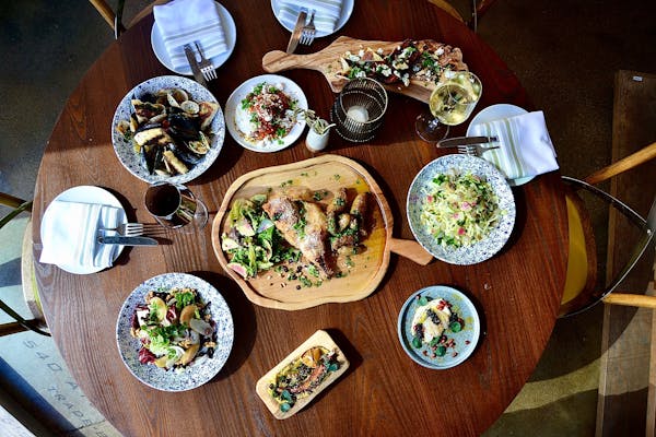 a close up of many different types of Greek food at Tradeon a table