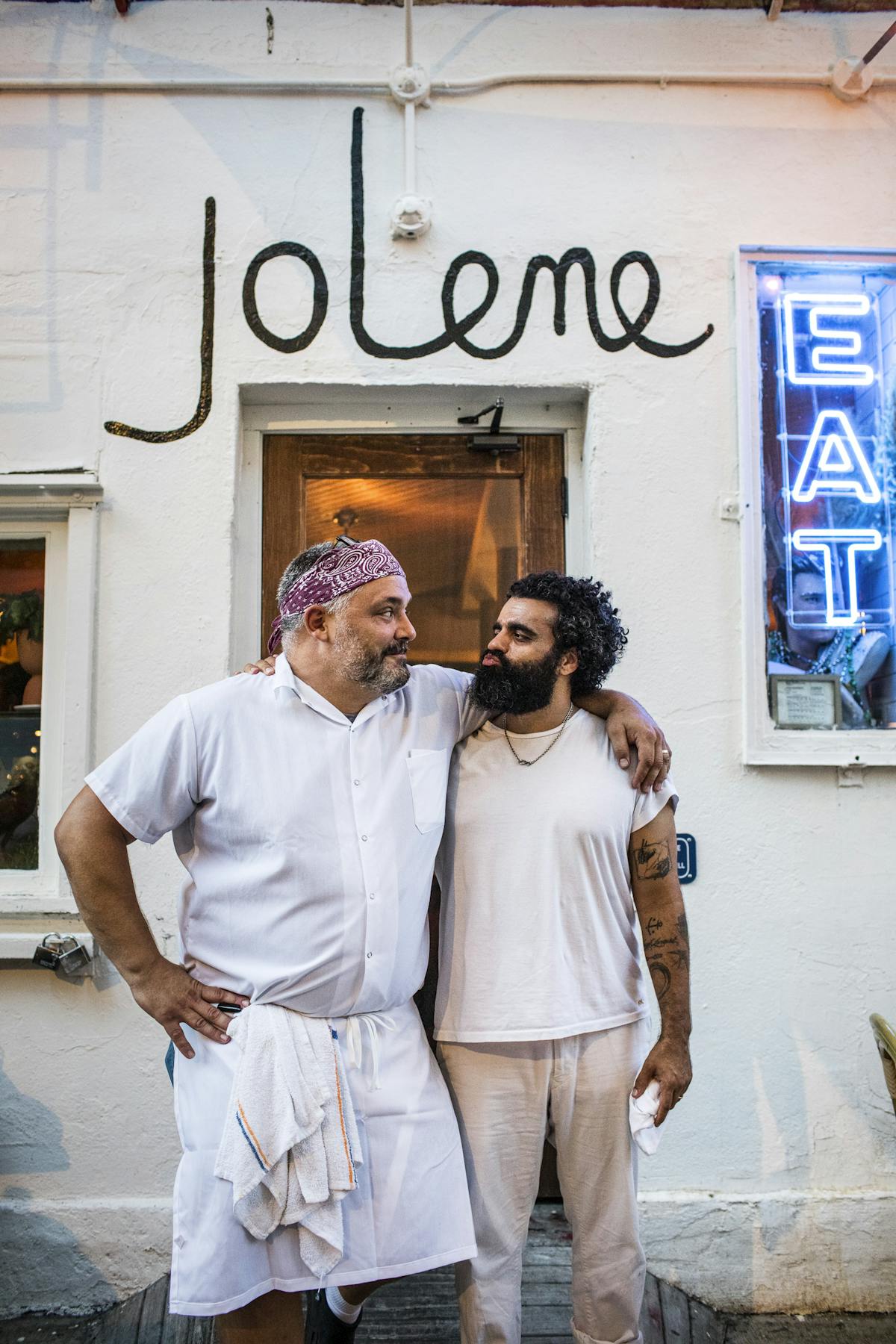 chef and owner embracing