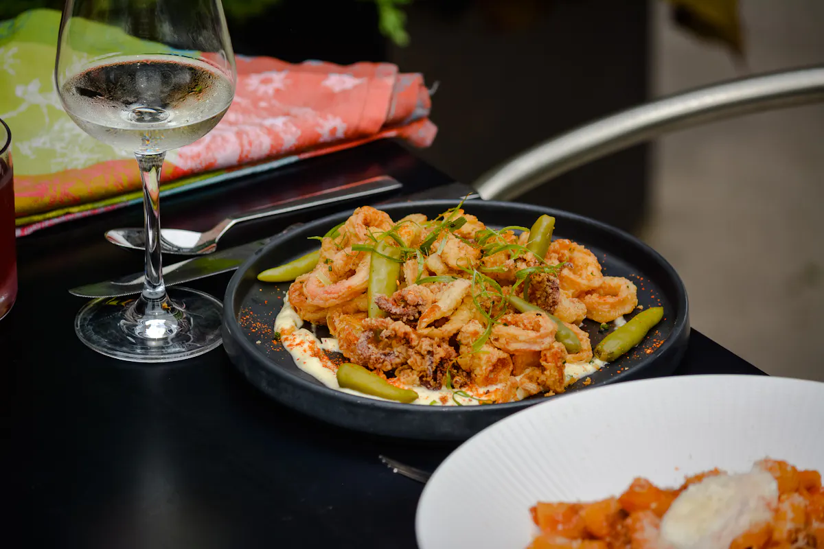 a plate of food and a glass of wine