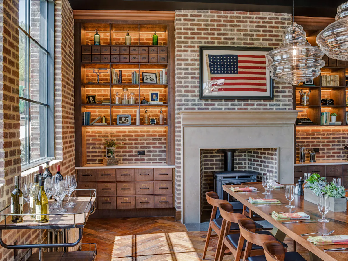 dining room with american flag picture above fireplace