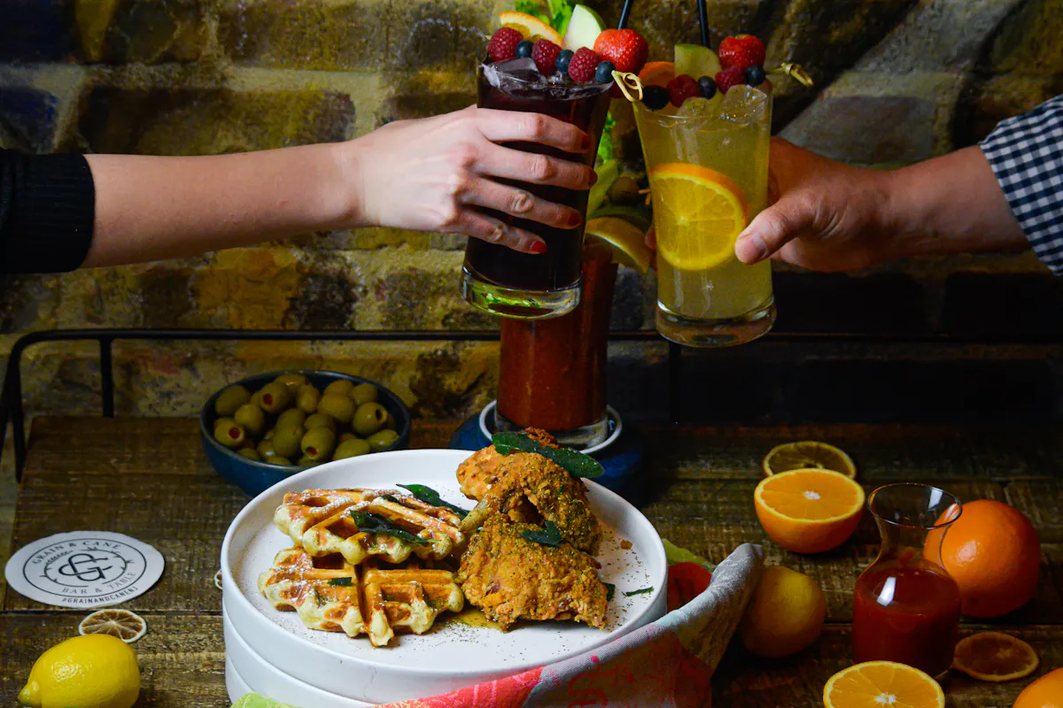 a person holding a plate of food on a table