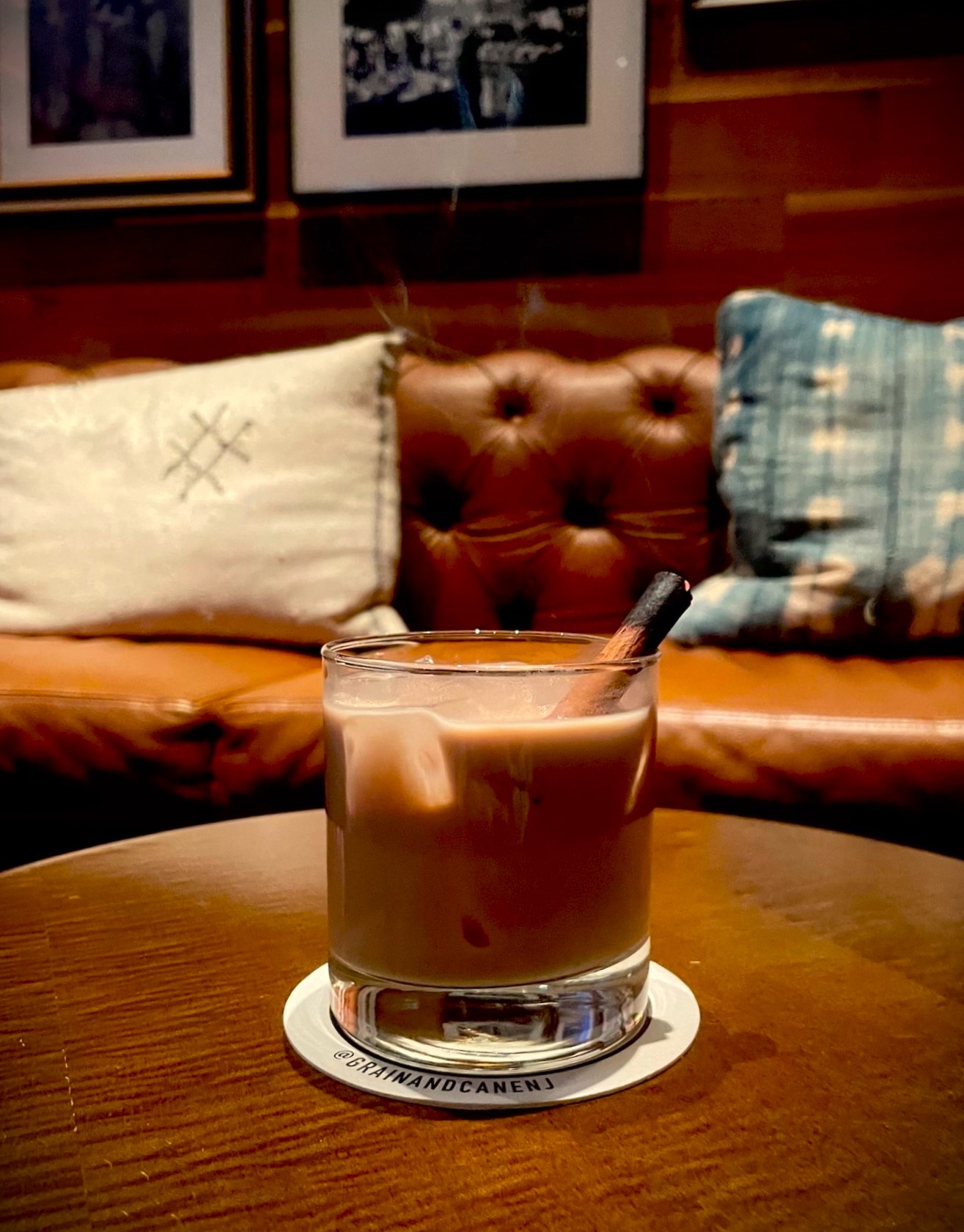 a cup of coffee sitting on top of a wooden table