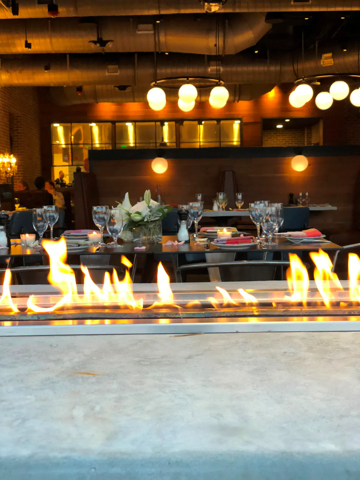 a close of of table top fireplace with bar background