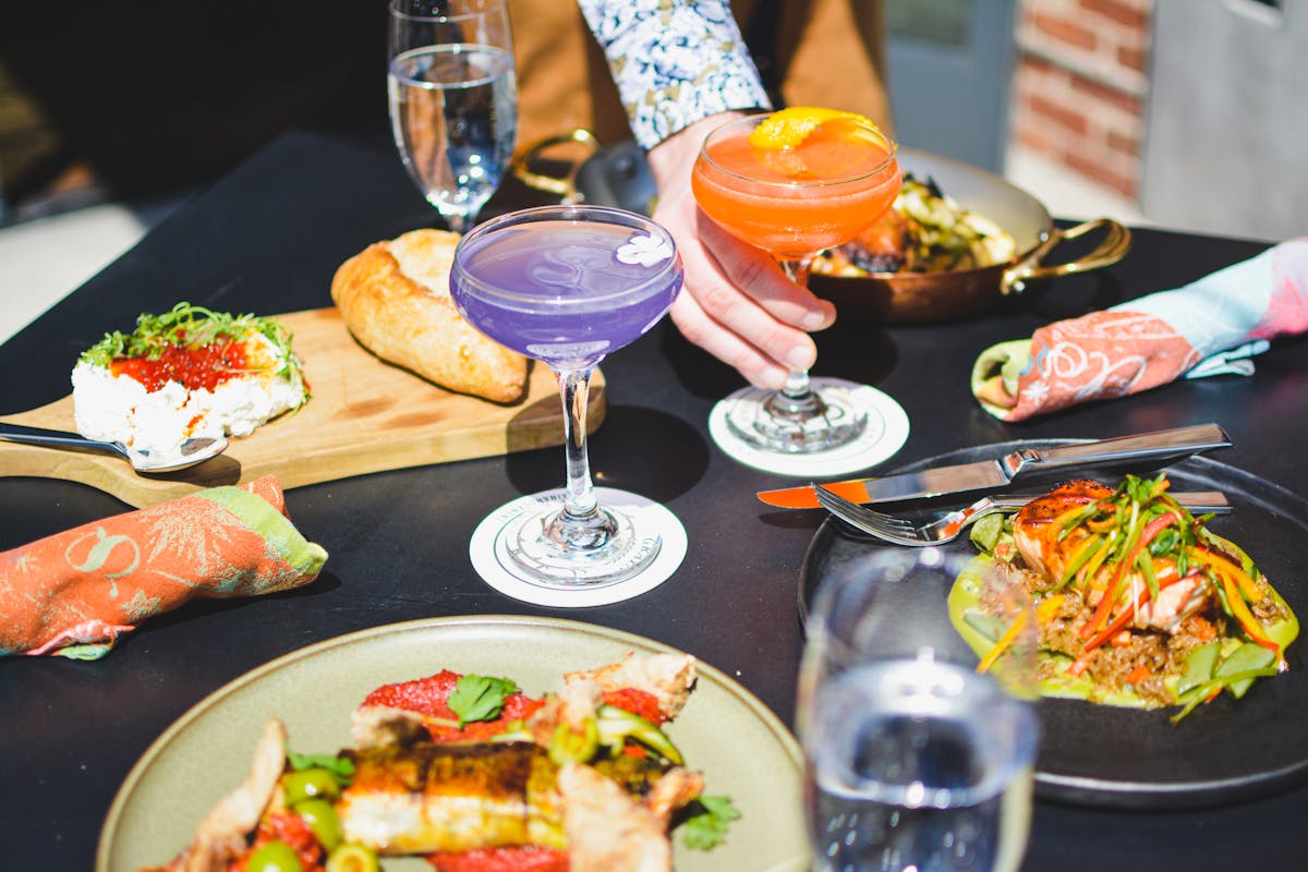 a group of people sitting at a table with a plate of food