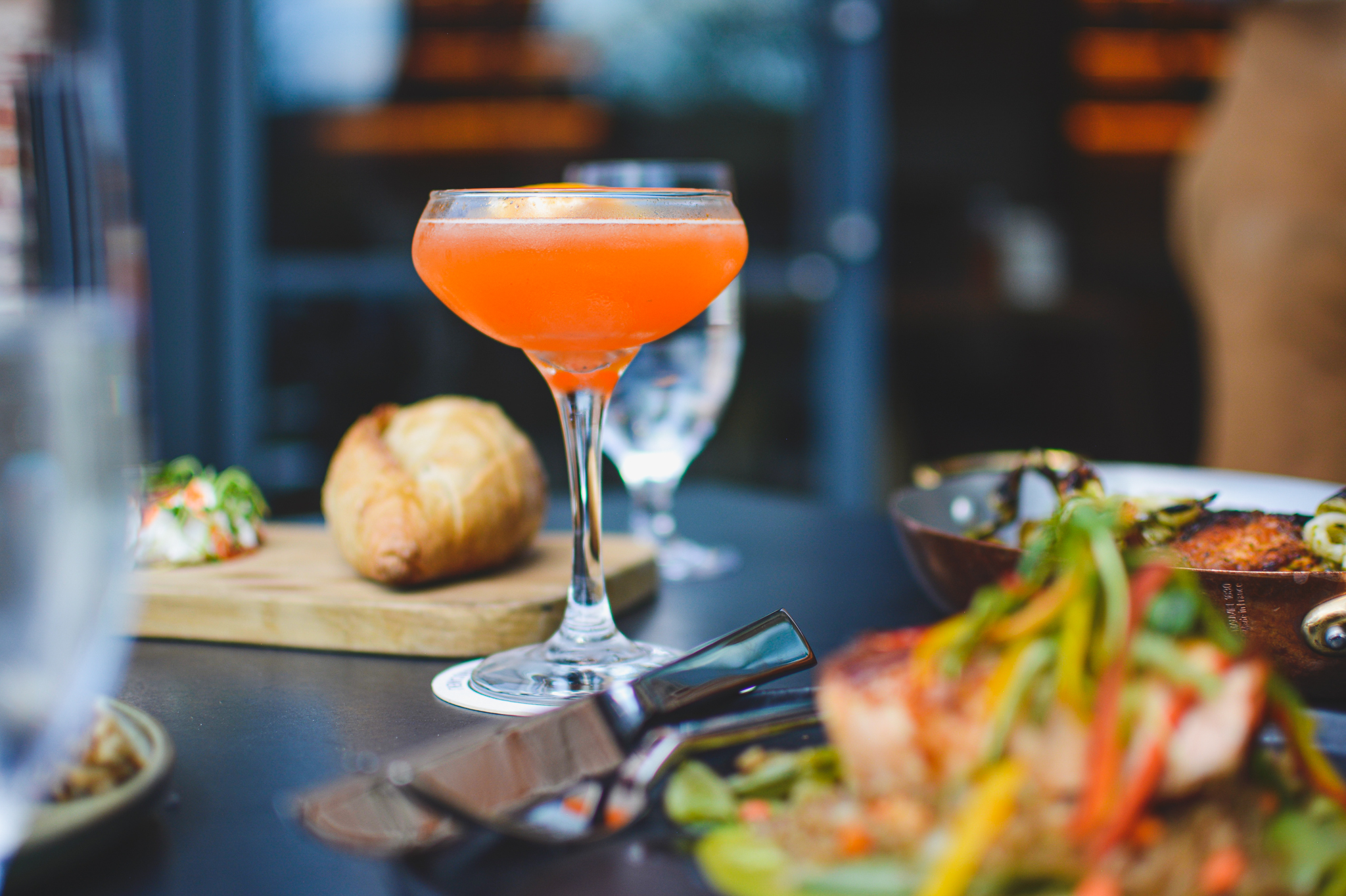 a close up of a plate of food and a glass of wine