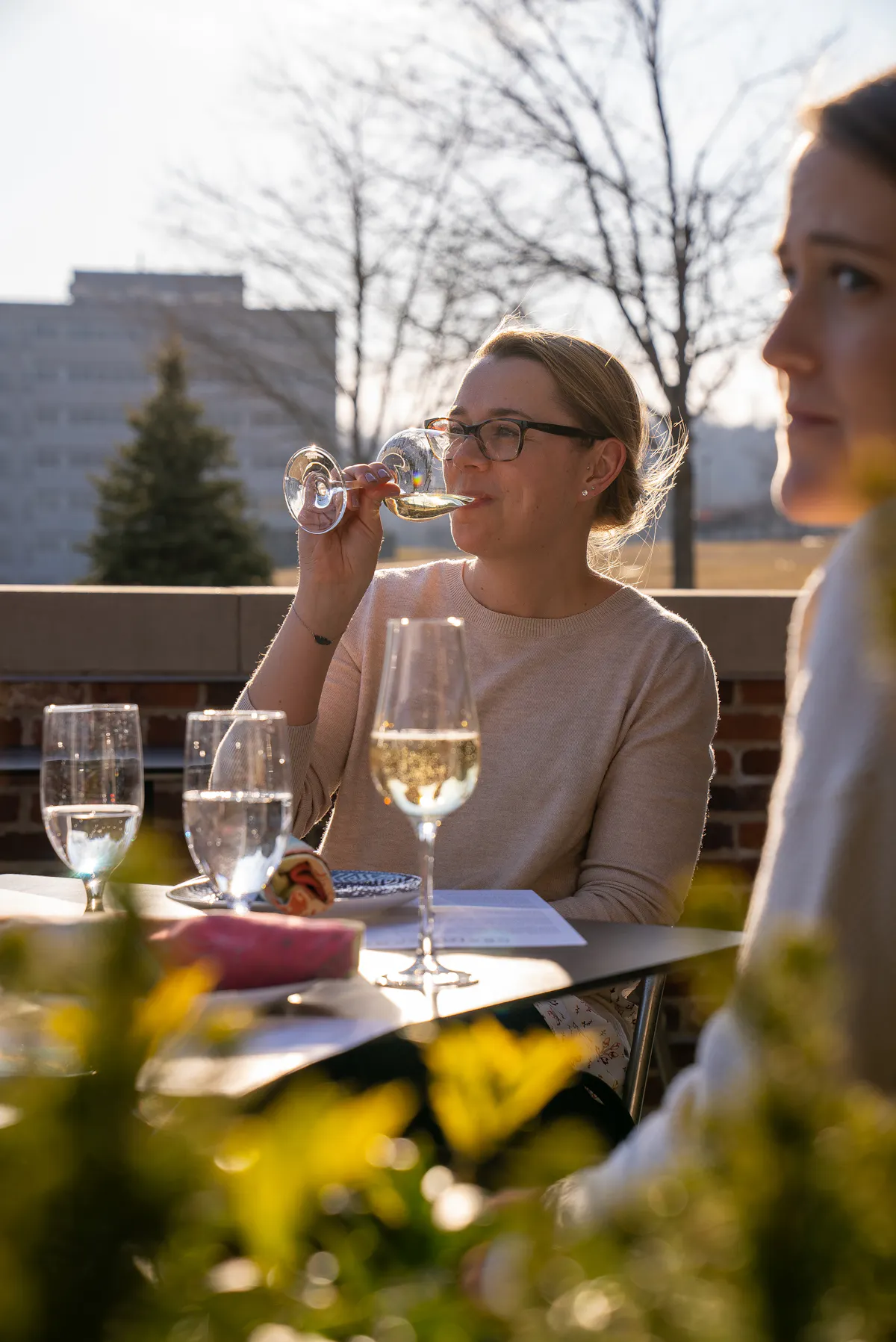 a man and a woman sitting at a table with wine glasses