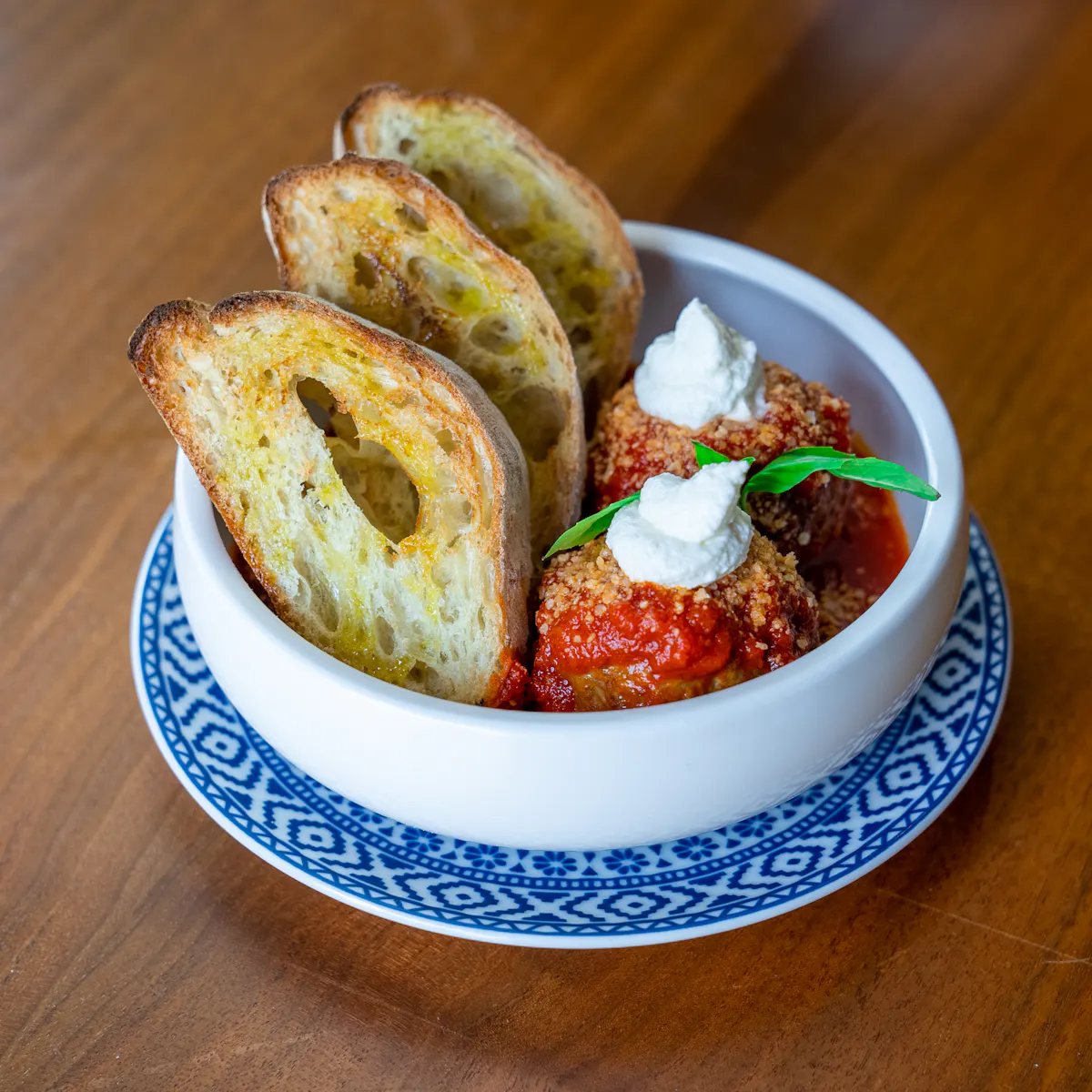 a plate of food sitting on top of a wooden table