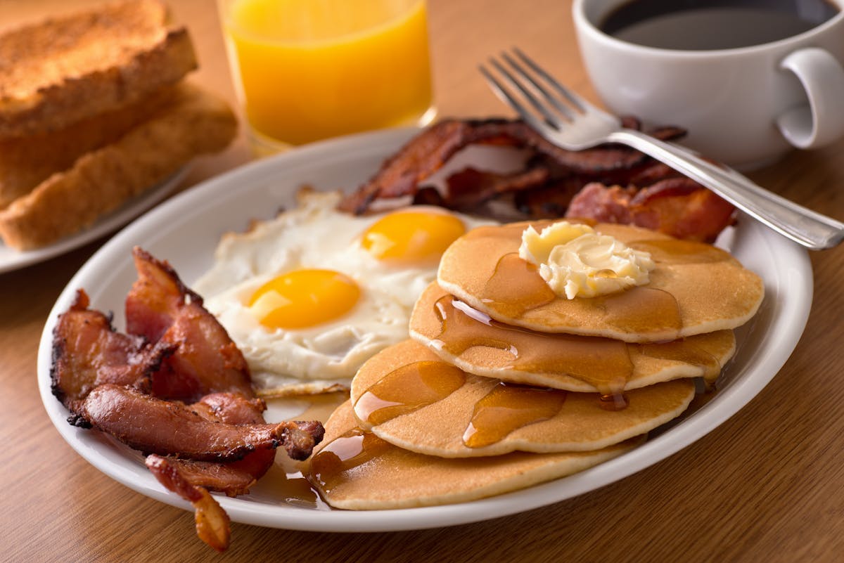 a plate of food and a cup of coffee