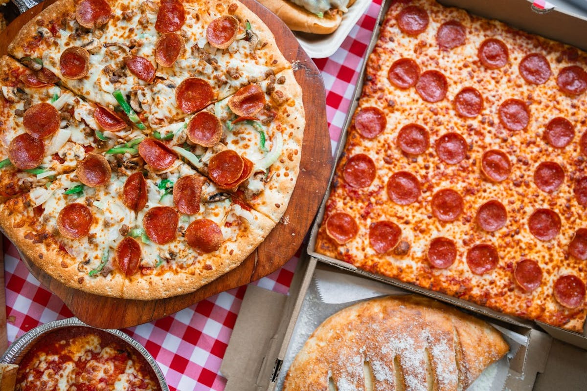 a pizza sitting on top of a pan on a table