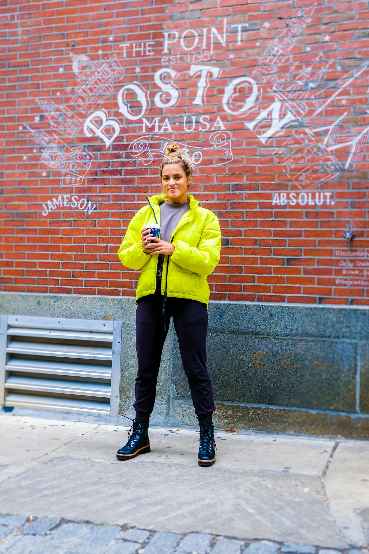a person standing in front of a brick building