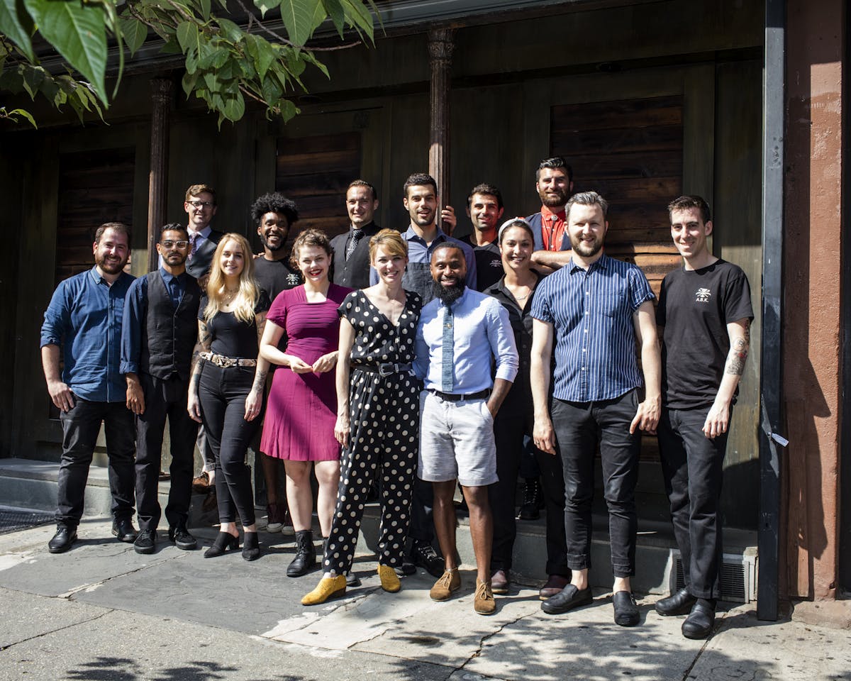 a group of people standing in front of a crowd posing for the camera