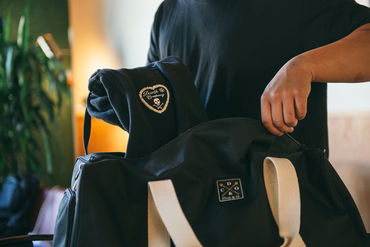 a person holding a bag of luggage