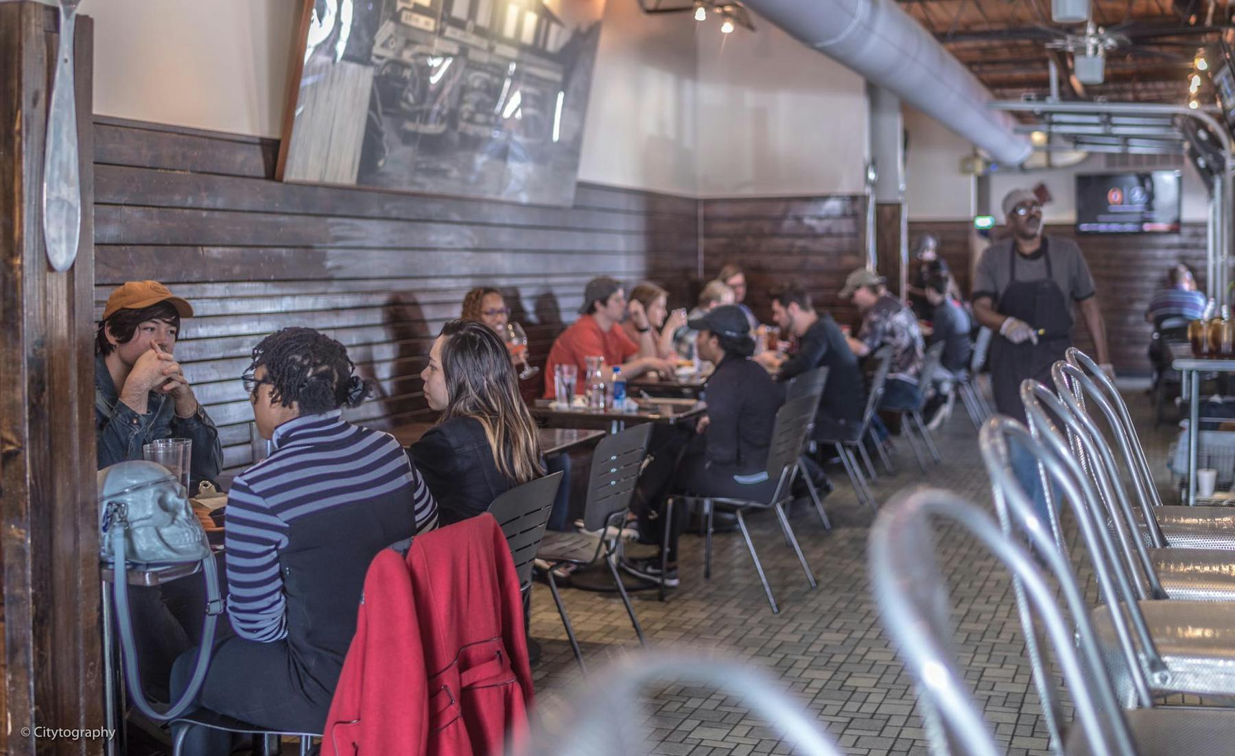 a group of people sitting at a table in a restaurant