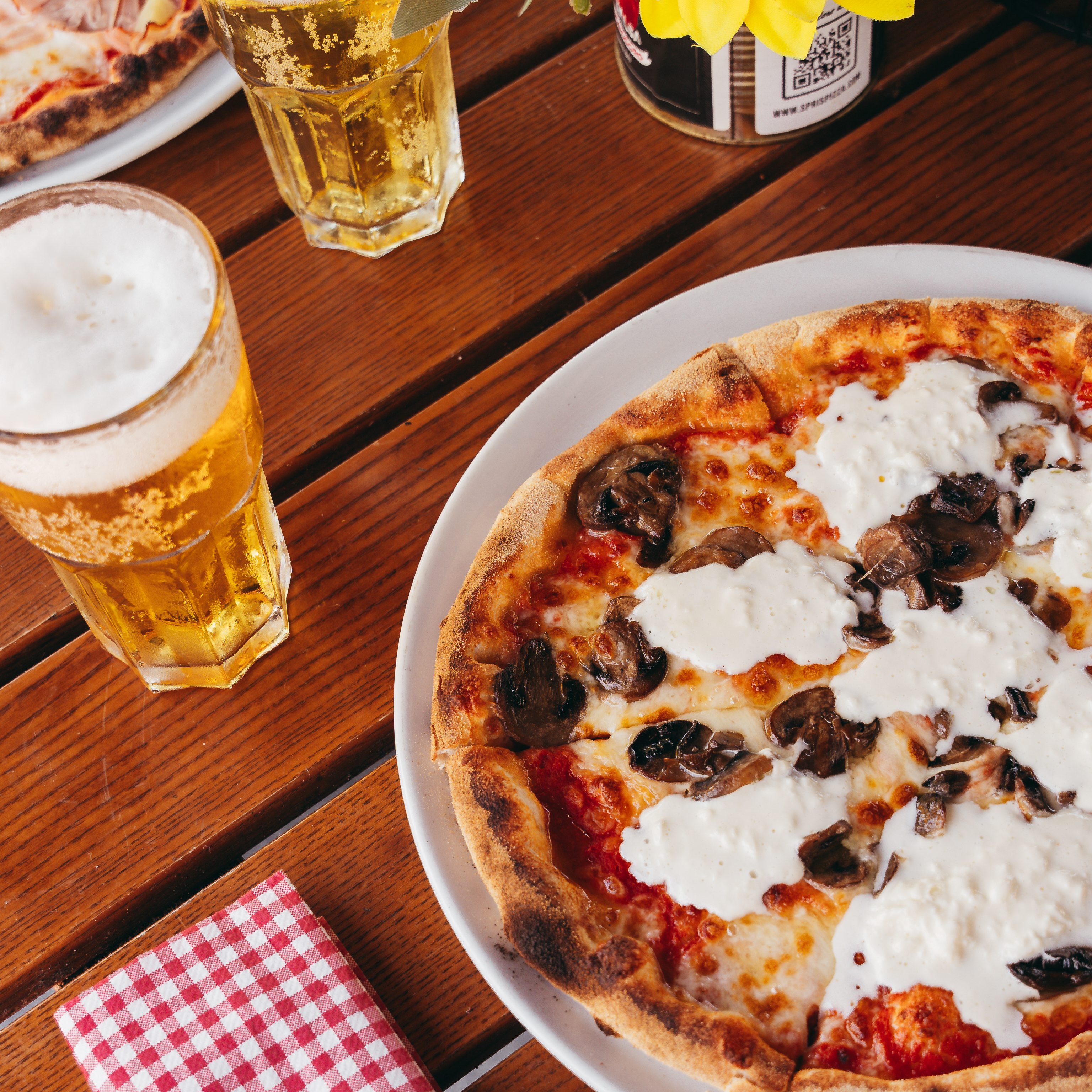 a pizza sitting on top of a wooden table