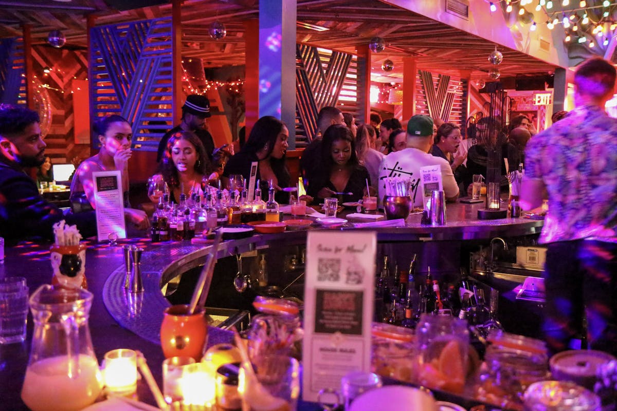 a group of people sitting at a table in a restaurant