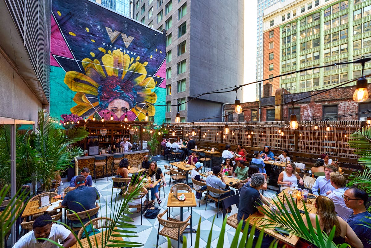 a group of people sitting at a table in front of a building