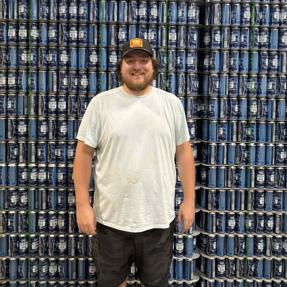 a man standing in front of a fence