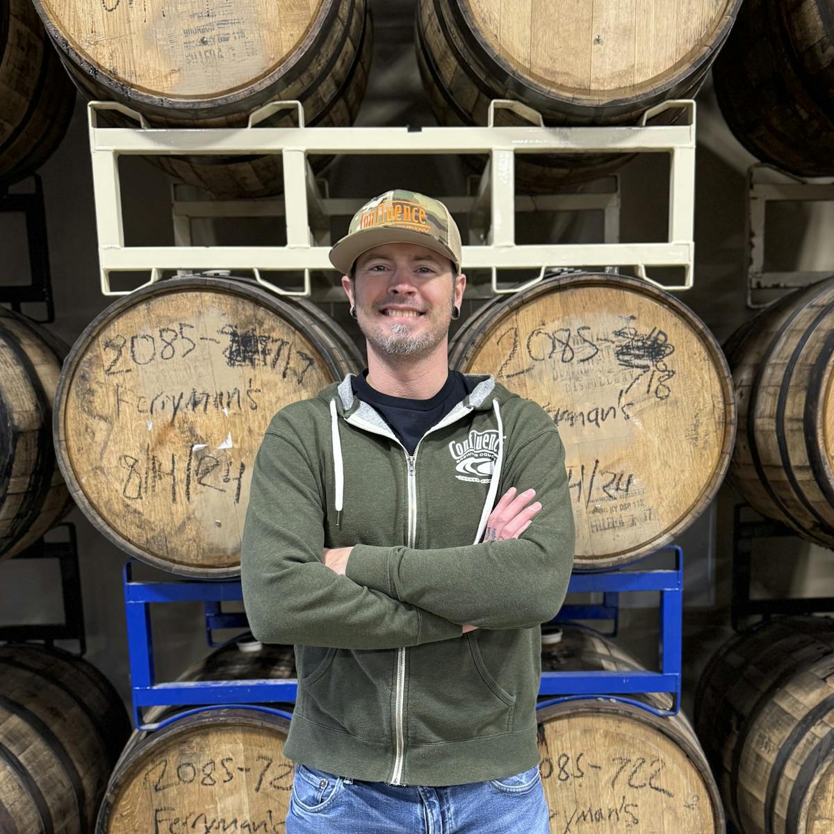 a man standing in front of a barrel