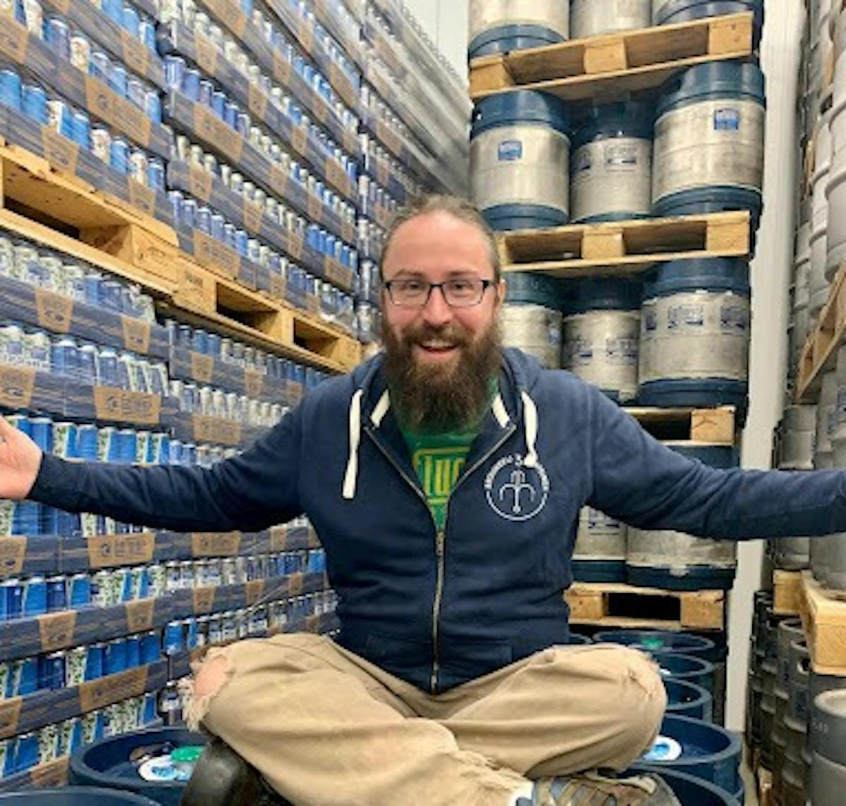 a man sitting in front of a barrel