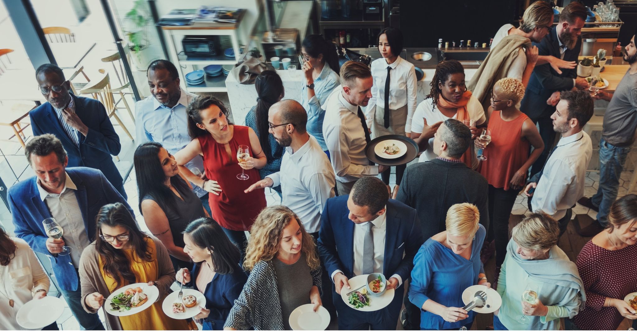 a group of people sitting at a table in front of a crowd