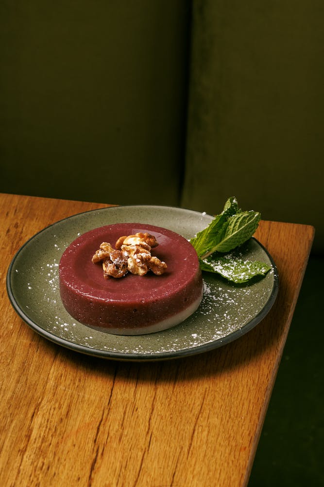 a pink flower is standing in front of a building