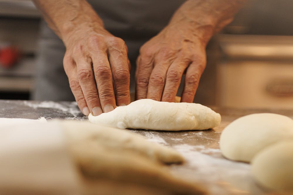 a room filled with furniture and vase of flowers on a table