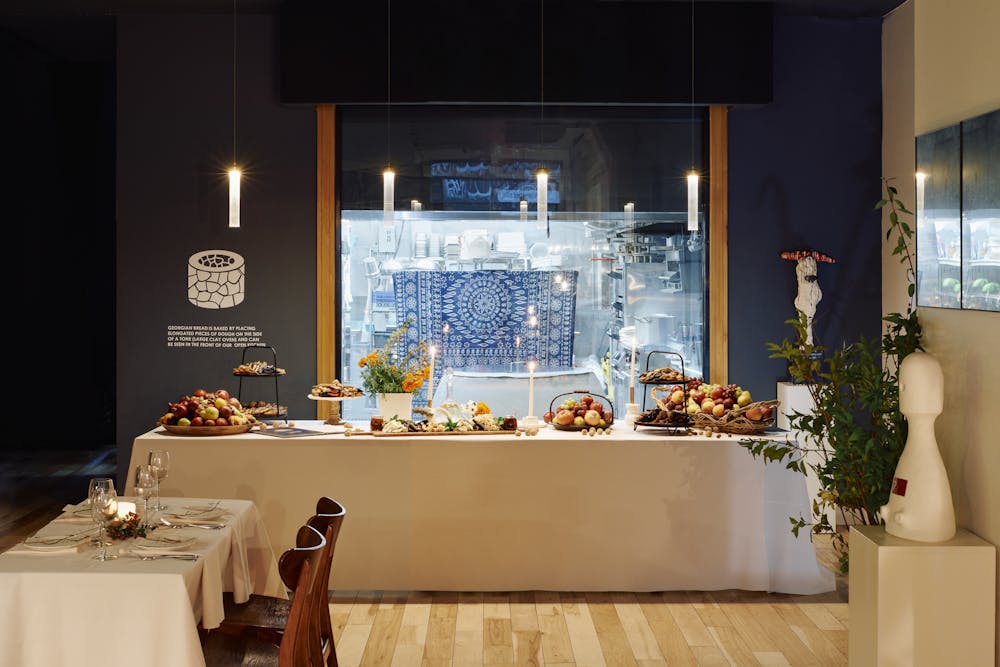 a room filled with furniture and vase of flowers on a table