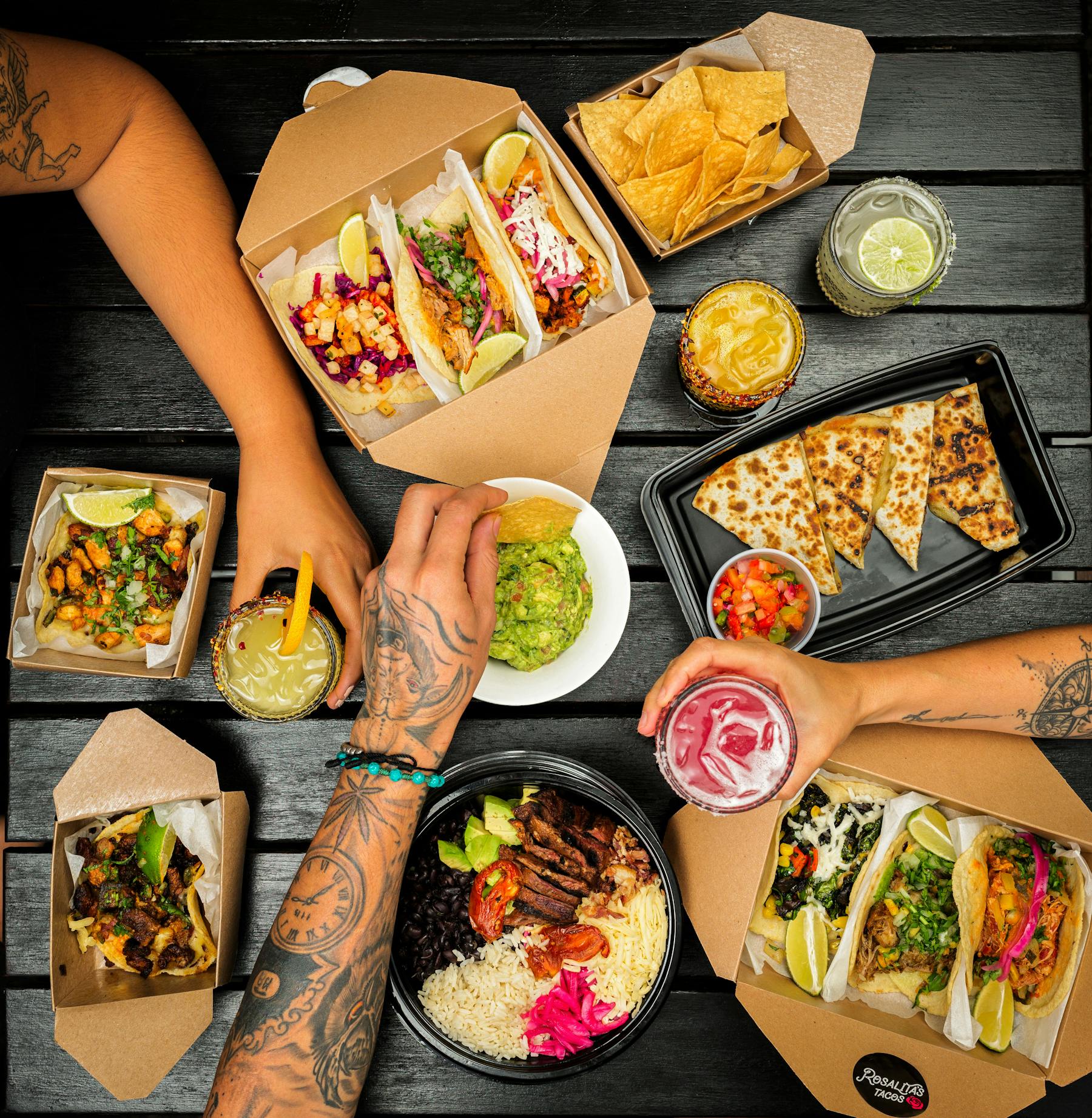 a person sitting at a table with plates of food