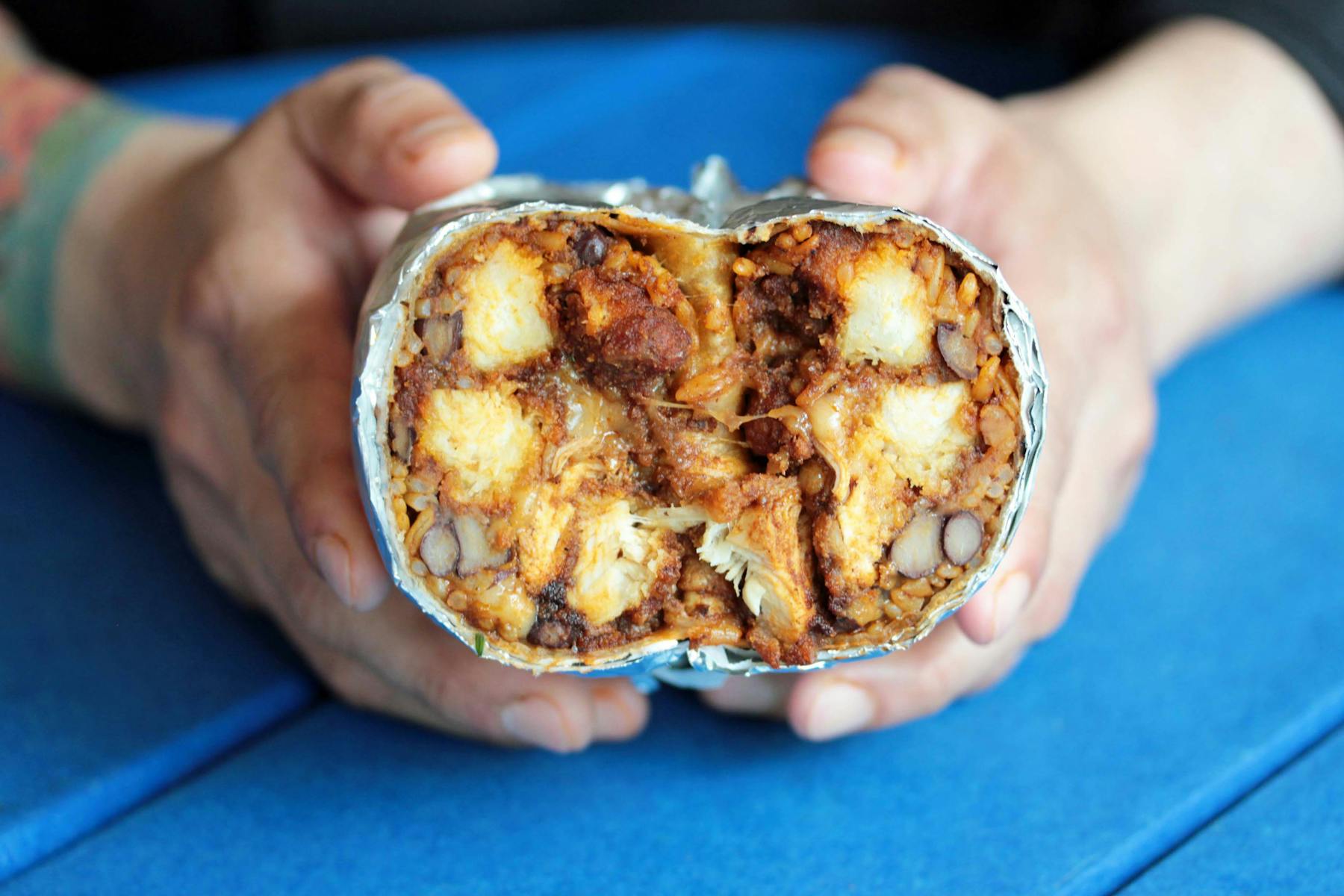 a hand holding a small piece of food