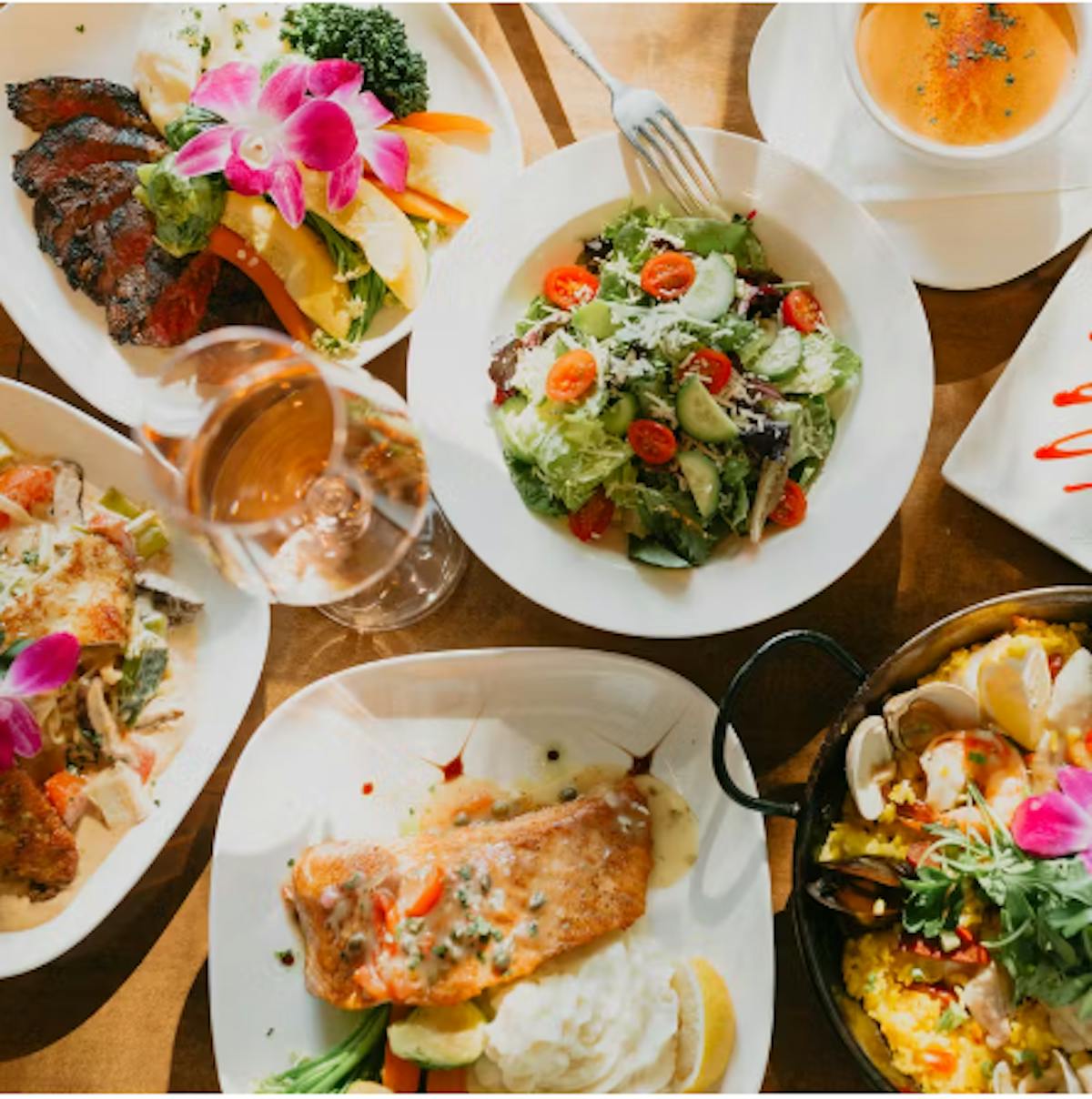 An image of different Asian fusion dishes such as Salmon, salad, etc.