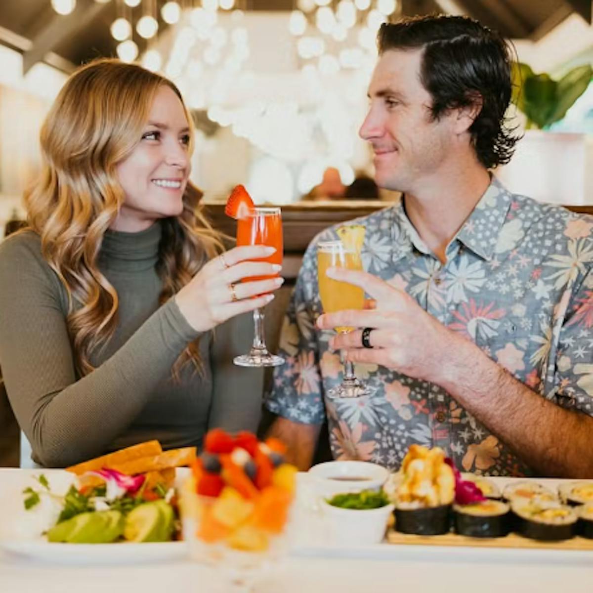 An image of a couple with drinks and food at Pangaea On Ocean Ave