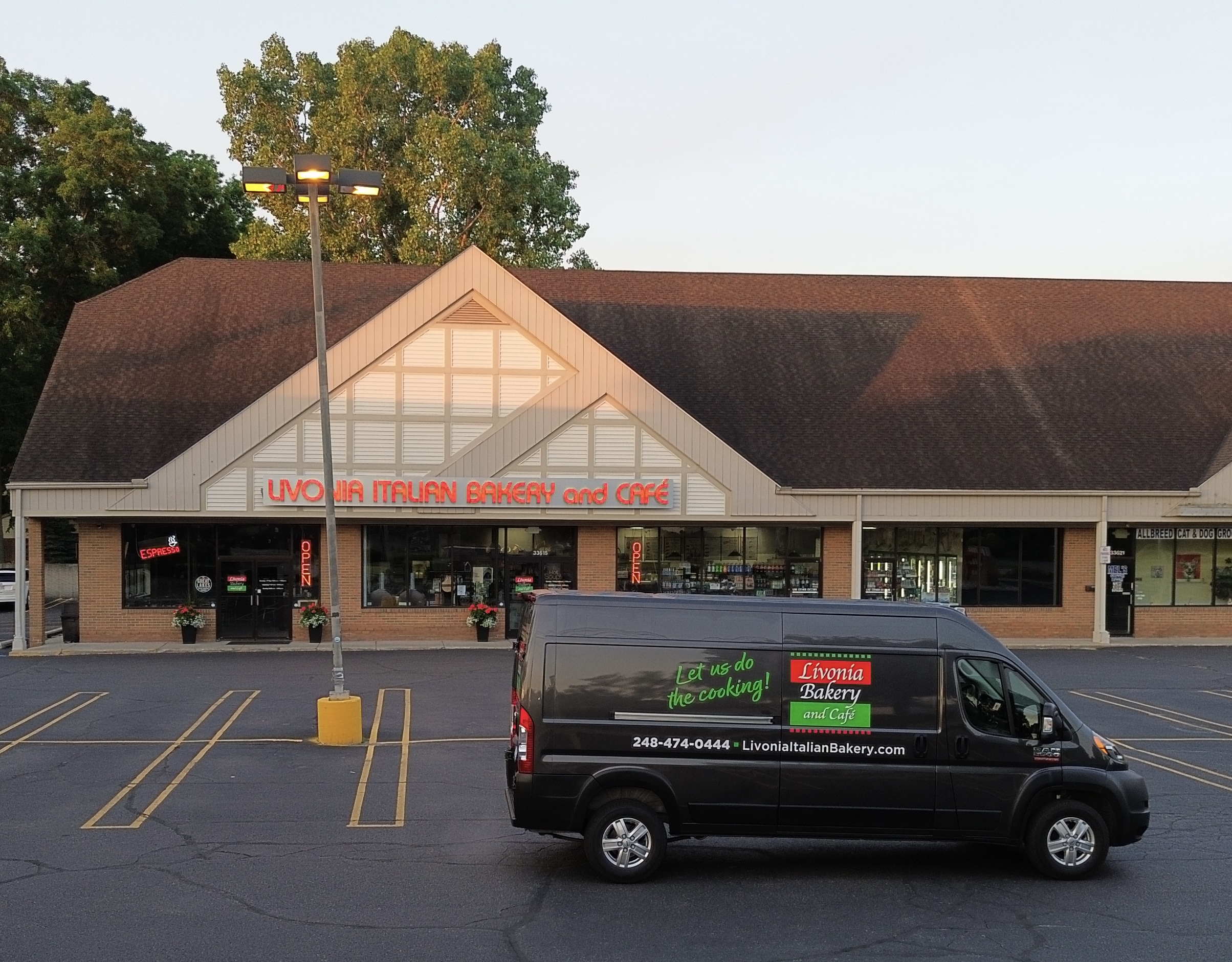 Delivery van parked in front of store.