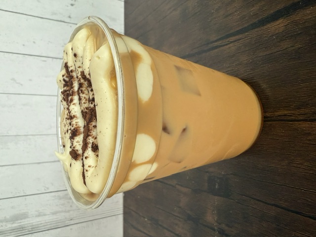 a cup of coffee with whipped cream and chocolate chips