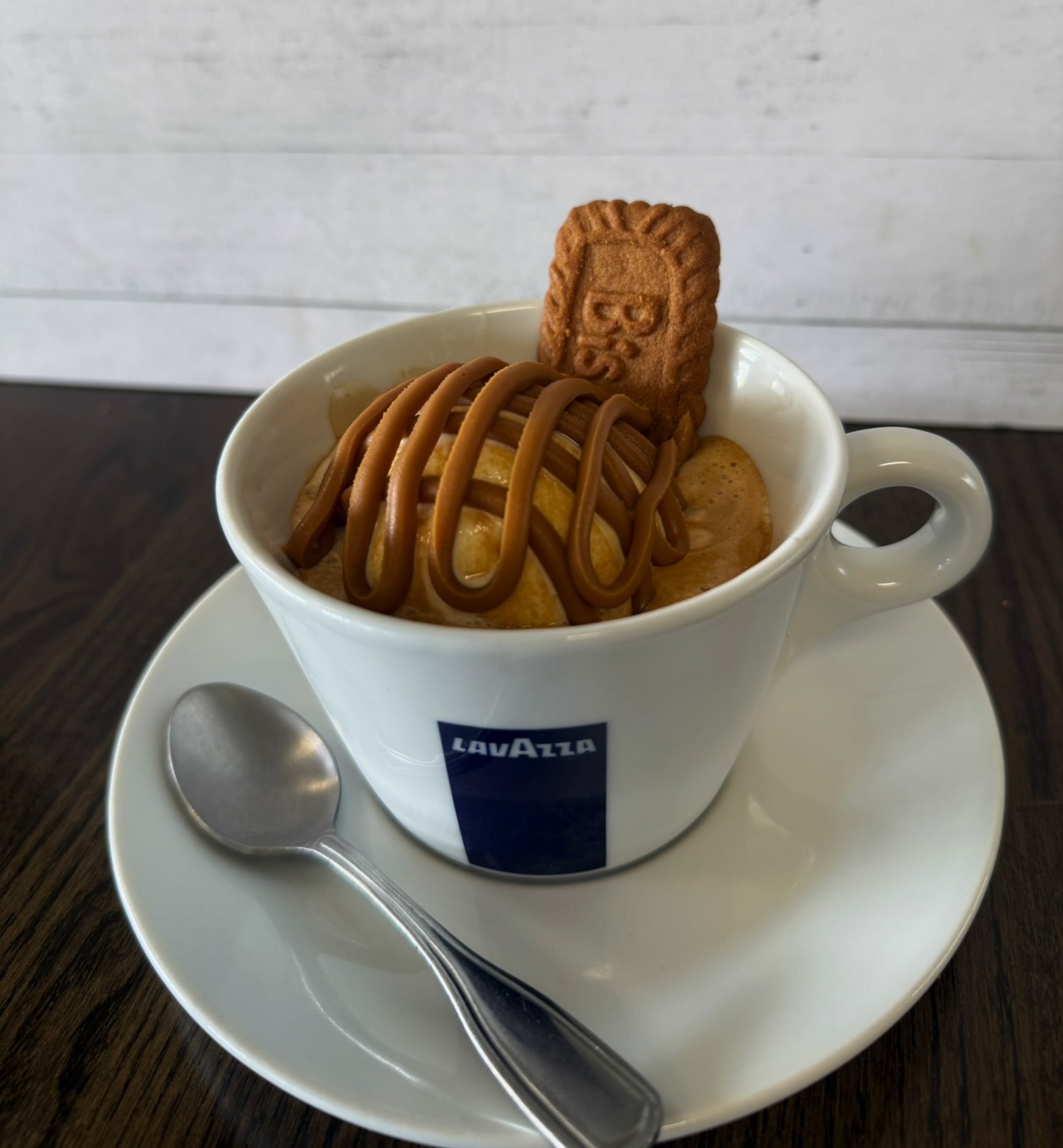 a cup of ice cream with a cookie and a spoon