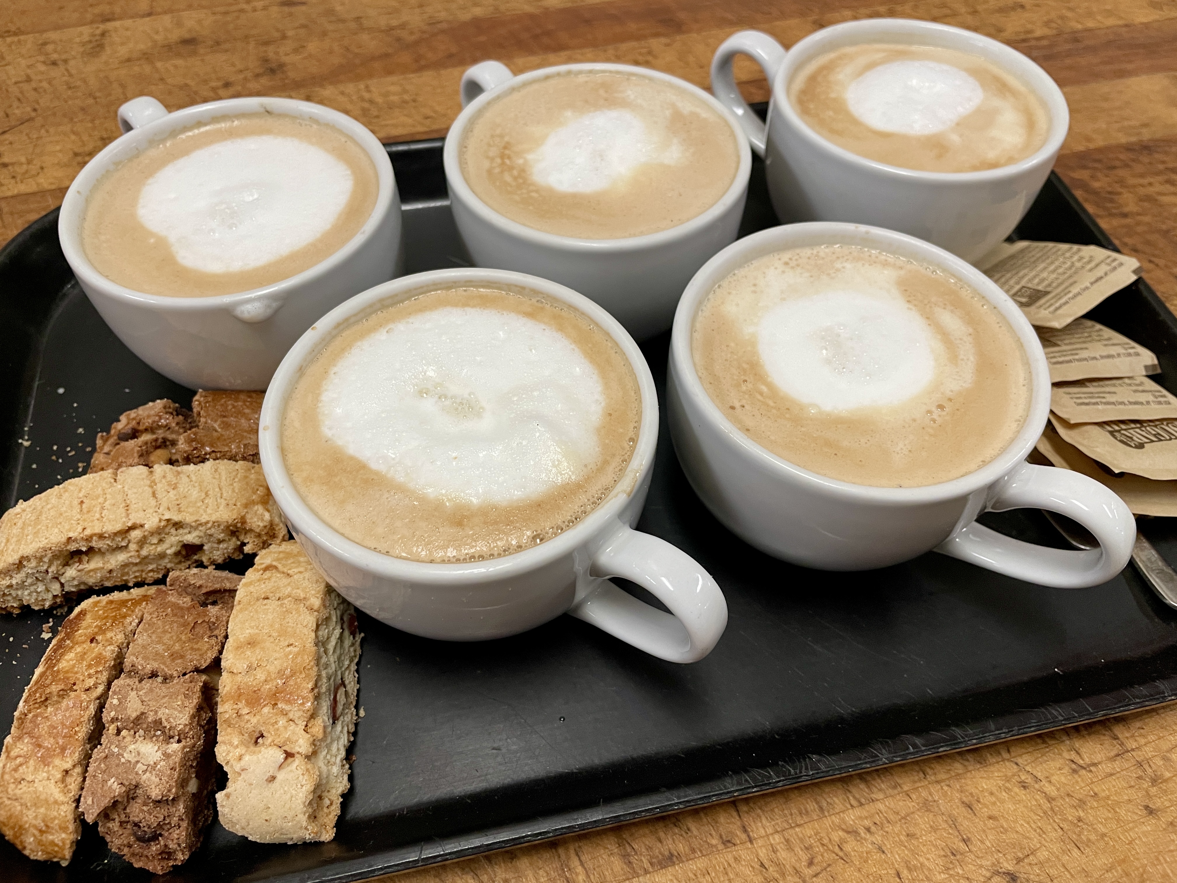 Cappuccino in ceramic cups, with almond biscotti
